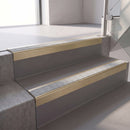Square edge with ramped back aluminium stair nosing, 70mm tread, everest (light grey) exterior grip insert, satin gold finish