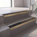 Square edge with ramped back aluminium stair nosing, 70mm tread, obsidian (dark charcoal) Mor Grip insert, satin gold finish