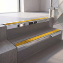 Square edge with ramped back aluminium stair nosing, 70mm tread, solar (golden yellow) Mor Grip insert, bright polished finish