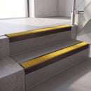Square edge with ramped back aluminium stair nosing, 70mm tread, solar (golden yellow) Mor Grip insert, dark bronze finish