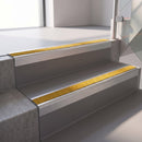 Square edge with ramped back aluminium stair nosing, 70mm tread, solar (golden yellow) Mor Grip insert, mill finish finish