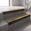 Square edge with ramped back aluminium stair nosing, 70mm tread, solar (golden yellow) Mor Grip insert, satin black finish