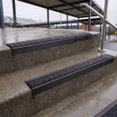 Square edge with ramped back aluminium stair nosing with black gritted exterior grip insert in satin black finish fitted on covered external concrete steps