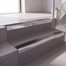 Square edge with ramped back aluminium stair nosing with a dark charcoal Mor Grip insert in bright polished finish fitted on a hospital entrance stair finished in grey safety vinyl