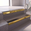 Square edge with ramped back aluminium stair nosing with a dark charcoal Mor Grip insert in mirrorflect gold finish fitted on a hospital entrance stair finished in grey safety vinyl