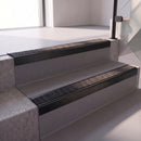 Square edge with ramped back aluminium stair nosing with a dark charcoal Mor Grip insert in satin black finish fitted on a hospital entrance stair finished in grey safety vinyl