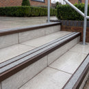Ramp back twin channel aluminium stair nosing 93 x 38mm in Dark Bronze with two Everest gritted Exterior Grip inserts, fitted on wet outdoor entrance steps