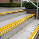 Ramp back twin channel aluminium stair nosing 93 x 38mm in Mirrorflect Gold with two Brimstone gritted Exterior Grip inserts, fitted on wet outdoor entrance steps