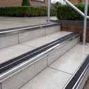 Ramp back twin channel aluminium stair nosing 93 x 38mm in Mirrorflect Silver with two Coal gritted Exterior Grip inserts, fitted on wet outdoor entrance steps
