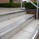 Ramp back twin channel aluminium stair nosing 93 x 38mm in Mirrorflect Silver with two Everest gritted Exterior Grip inserts, fitted on wet outdoor entrance steps