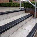 Ramp back twin channel aluminium stair nosing 93 x 38mm in Satin Black with two Coal gritted Exterior Grip inserts, fitted on wet outdoor entrance steps