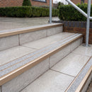 Ramp back twin channel aluminium stair nosing 93 x 38mm in Satin Bronze with two Everest gritted Exterior Grip inserts, fitted on wet outdoor entrance steps