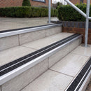 Ramp back twin channel aluminium stair nosing 93 x 38mm in Satin Silver with two Coal gritted Exterior Grip inserts, fitted on wet outdoor entrance steps
