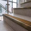 Antique brass ramped stair nosing with amber carborundum insert fitted to concrete steps