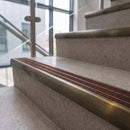 Antique brass ramped stair nosing with chestnut carborundum insert fitted to concrete steps