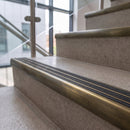 Antique brass ramped stair nosing with graphite carborundum insert fitted to concrete steps