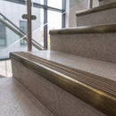 Antique brass ramped stair nosing with hazelnut carborundum insert fitted to concrete steps