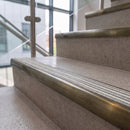 Antique brass ramped stair nosing with Italian marble carborundum insert fitted to concrete steps