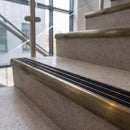 Antique brass ramped stair nosing with obsidian carborundum insert fitted to concrete steps