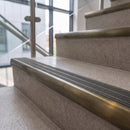Antique brass ramped stair nosing with pebble carborundum insert fitted to concrete steps