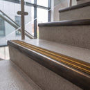 Antique bronze ramped stair nosing with amber carborundum insert fitted to concrete steps