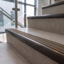 Antique bronze ramped stair nosing with hazelnut carborundum insert fitted to concrete steps