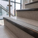 Antique bronze ramped stair nosing with Italian marble carborundum insert fitted to concrete steps