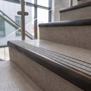 Antique bronze ramped stair nosing with speckled pebble carborundum insert fitted to concrete steps