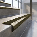 Antique Brass finish - solid brass raked back stair nosing with CarbiGrip - Amber insert fitted on concrete steps
