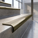 Antique Brass finish - solid brass raked back stair nosing with CarbiGrip - Chalk insert fitted on concrete steps