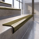 Antique Brass finish - solid brass raked back stair nosing with Ridged PVC - Canary insert fitted on concrete steps