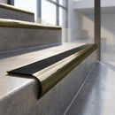 Antique Brass finish - solid brass raked back stair nosing with Ridged PVC - Carbon insert fitted on concrete steps