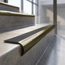 Antique Brass finish - solid brass raked back stair nosing with Ridged PVC - Storm insert fitted on concrete steps