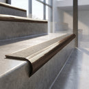 Antique Bronze finish - solid brass raked back stair nosing with CarbiGrip - Chalk insert fitted on concrete steps