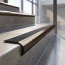 Antique Bronze finish - solid brass raked back stair nosing with CarbiGrip - Speckled Obsidian insert fitted on concrete steps