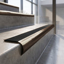 Antique Bronze finish - solid brass raked back stair nosing with Ridged PVC - Carbon insert fitted on concrete steps