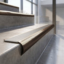 Antique Bronze finish - solid brass raked back stair nosing with Ridged PVC - Snow insert fitted on concrete steps