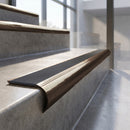 Antique Bronze finish - solid brass raked back stair nosing with Ridged PVC - Storm insert fitted on concrete steps