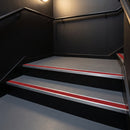 Red PVC insert fitted in aluminium stair nosings on a theatre back stair