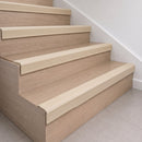 Beige 70x40mm rubber stair nosing fitted along the front edge of every oak veneer step in a home staircase