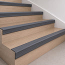 Dark grey 70x40mm rubber stair nosing fitted along the front edge of every oak veneer step in a home staircase