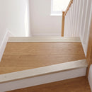 Champagne anodised aluminium ribbed stair nosing edge trim 40x20mm fitted to oak stair treads at a first-floor landing