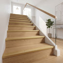 Gold anodised aluminium ribbed stair nosing edge trim 40x20mm fitted to oak stair treads in a modern home hallway