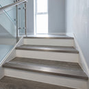 Inox stainless-steel-effect anodised aluminium ribbed stair nosing edge trim 40x20mm fitted on grey vinyl steps in an apartment communal stairwell