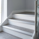 Silver anodised aluminium ribbed stair nosing edge trim 40x20mm fitted on grey vinyl steps in an apartment communal stairwell