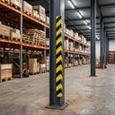 Black and yellow striped foam right angle guard fitted to a steel column corner in a warehouse aisle with pallet racking behind