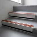 Rustic Castellated insert in a 66x55mm square front aluminium stair nosing with 13mm black riser highlight, fitted to interior steps