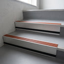 Rustic Castellated insert in a cut to size 66x55mm aluminium stair nosing with 13mm black riser highlight, fitted to interior steps