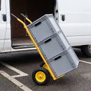Yellow 200kg sack truck with puncture proof wheels carrying three grey plastic stacking crates beside the open rear doors of a white delivery van