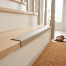 Beige self adhesive stair nosing fitted to a light oak step edge in a bright hallway